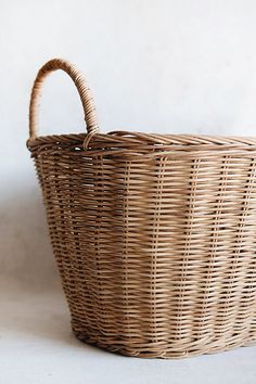 a wicker basket sitting on top of a white table