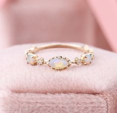 Vintage Marquise Opal Wedding Band, Natural Australia Opal Anniversary Band, Rose Gold October Birthstone Rings, Rainbow Opal Dainty Ring ✧･ﾟ: *✧･ﾟ:* Welcome to Charles Davin Jewelry*:･ﾟ･ﾟ✧ ✶Material: 10K/ 14K/ 18K ✶Main Stone: Marquise Cut Natural Australia Opal; 2.5*5mm ✶Side Stone: Moissanite; Total: 0.002ct ✶Color: D Colorless ✶Clarity: VVS1 ✶Cut: Excellent ✶Width of band: 1.5mm ✶Thickness of band: 1.1mm OR ✶Side Stone: Diamond ✶Color: F-G ✶Clarity: SI1 PRODUCTION TIME My team of jewelry art Peach Morganite Engagement Ring, Opal Stacking Ring, Opal Wedding Band, Rose Gold Opal Ring, October Birthstone Rings, Opal Wedding, Birthstone Rings, Opal Wedding Rings, Rainbow Opal