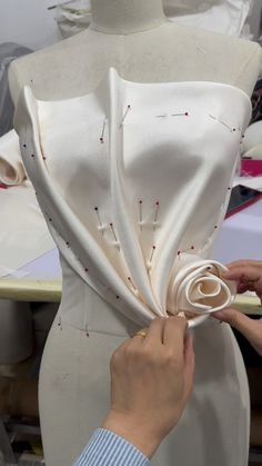 a woman is working on a dress