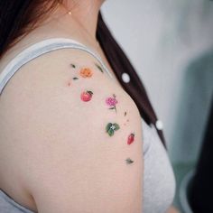 a woman with flowers painted on her shoulder