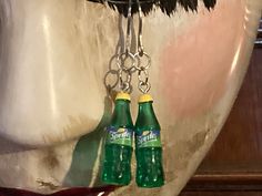 Stainless steel earring hooks with green and yellow sprite bottle charms. Prescription Bottle Earrings, Handcuff Necklace, Bottle Earrings, Bottle Charms, Stainless Steel Earrings, Ear Wire, Jewelry Earrings Dangle, Etsy Earrings, Dangle Drop Earrings