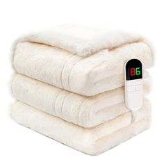 three blankets stacked on top of each other with an electronic thermometer attached to them