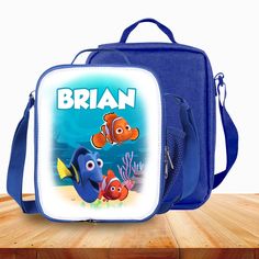 a lunch box with an image of the character finding nemo on it, sitting on top of a wooden table