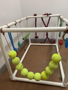 tennis balls are arranged in the shape of a cage