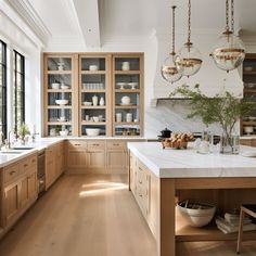 a kitchen filled with lots of wooden cabinets and counter top space next to a window