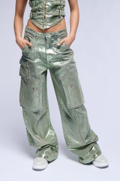 We’re so jelly of how fire you look in The AKIRA Label Green With Envy Metallic Wide Leg Cargo Pant. This glittery metallic-coated cotton denim blend bottom features a high rise waist, functional belt loops, slant side pockets, functional back pockets, and a wide leg silhouette. Complete with a small flap front pocket, dual zippered thigh pockets, and a zip button front closure. This convertible pair includes zip off hems for a cropped look. Style with the coordinating AKIRA Label Green With Envy Lace Up Corset Top for a finished ensemble.  - 75% Cotton 23% Polyester 2% Spandex - Little to No Stretch - Imported  (all measurements are approximate from size small) - 12” Rise - 32.5” Inseam - Model is 5’7”  Product ID: 391674 Black Maria, Lace Up Corset, Green With Envy, Cargo Pant, Corset Top, Front Pocket, Casual Pants, Wide Leg, High Rise