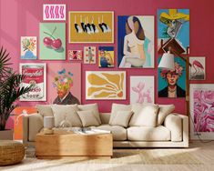 a living room with pink walls and lots of pictures on the wall, including a couch