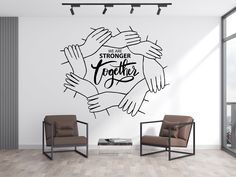 a wall decal with the words, we are strong together and hands holding each other