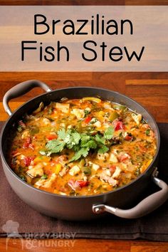 a pan filled with fish stew and garnished with cilantro