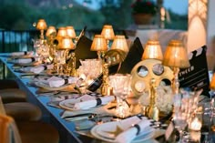 a long table is set up with candles and place settings for an elegant dinner party