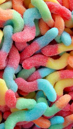 there are many different colored candies in the pile together and they look like worms