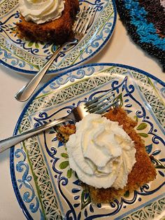 two blue and white plates with desserts on them, one has whipped cream in the middle