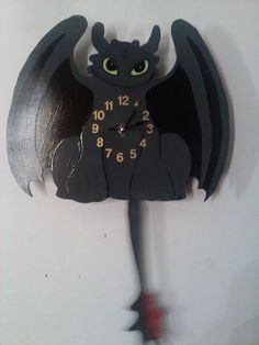 a black clock with a dragon on it