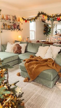 a living room filled with furniture and christmas decorations