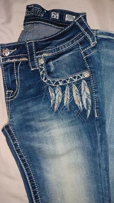 the jeans have feathers on them and beaded in with sequins or beads