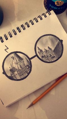 a drawing of harry potter's glasses on top of a notepad next to a pencil