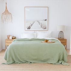 a bed with a green blanket on top of it