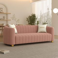 a living room with a pink couch and two white pillows on the back of it