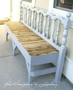 a white bench sitting on the side of a house next to a window and door