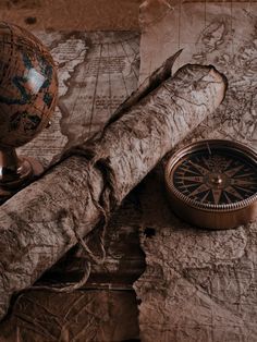 an old map, compass, and other items on a table