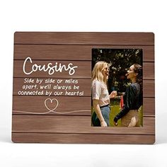 a wooden frame with two women talking to each other and the words coursins side by side on it