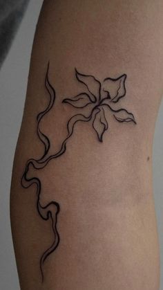 a black and white photo of a tattoo on the leg, with lines coming out of it