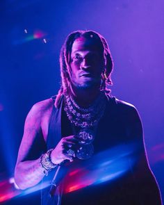 a man with dreadlocks holding a glass in his hand