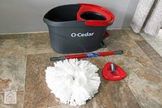 a mop, bucket and cleaning supplies on the floor