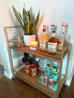 a bar cart filled with liquor bottles and glasses