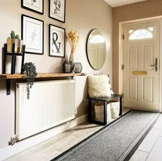 a living room with pictures on the wall and a radiator in front of it