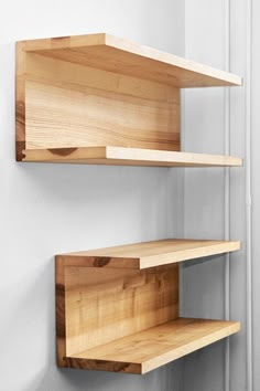 two wooden shelves mounted to the side of a wall