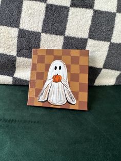 a piece of art depicting a white ghost on a chess board with black and white checkered background