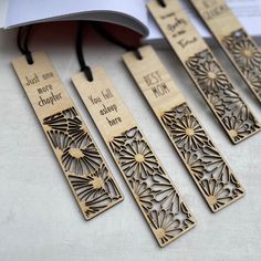 four wooden bookmarks with words on them