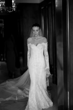 a woman in a wedding dress is walking down the aisle