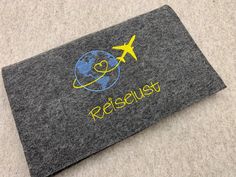 a felt case with the word rescue written on it and an airplane flying over the earth