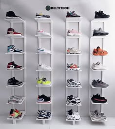 there are many different types of shoes on the shelves in this room and one is white