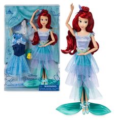 the little mermaid doll has red hair and blue dress