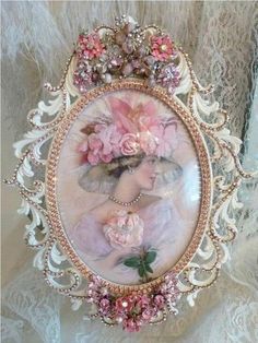 an ornate frame with pink flowers and pearls