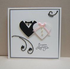 a white card with black and pink accents on it, featuring a bride and groom's heart