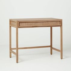 a wooden desk with a drawer on one side and an open drawer on the other