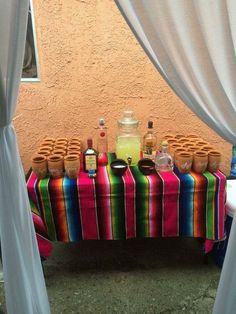 a colorful table with jars and bottles on it