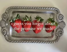 three strawberries on a metal tray with the words i guess you forgot about the promise we made