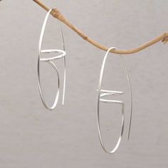 This pair of Balinese half-hoop earrings is handcrafted of sterling silver wire forming spiral shapes that dance around the ears. Diah Arini designs the earrings using her work to provide for her family. Spiral Shape, Garnet Earrings, Sterling Silver Dangle Earrings, Balinese, Silver Earrings Dangle, Hook Earrings, Silver Hoops