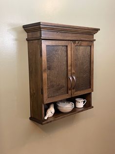 a wooden cabinet with two bowls on it