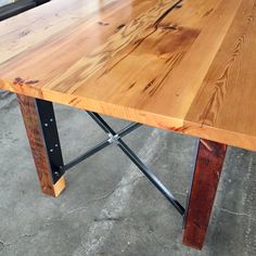 a wooden table sitting on top of a cement floor