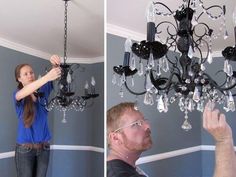 a man and woman are fixing a chandelier