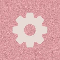 a pink background with a white cogwheel in the center on top of it