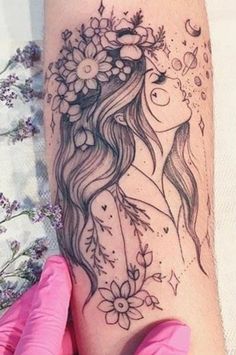 a woman's arm with flowers and butterflies on it