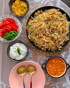 a table topped with bowls and plates filled with different types of food next to each other