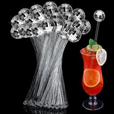 a glass vase filled with a red drink next to an orange and limeade cocktail